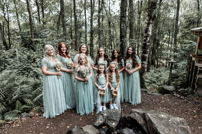Image showing the bridal party in blue dresses holding bouquets