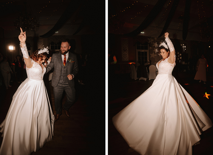 a bride spins in her long white dress with her hand up in celebration with the groom standing next to her