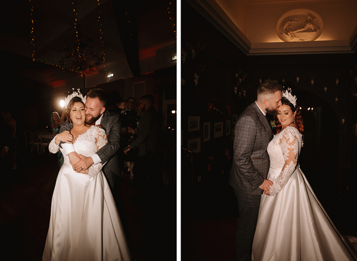 a first dance between a groom in a grey suit and a bride in a while dress on a dark dancefloor