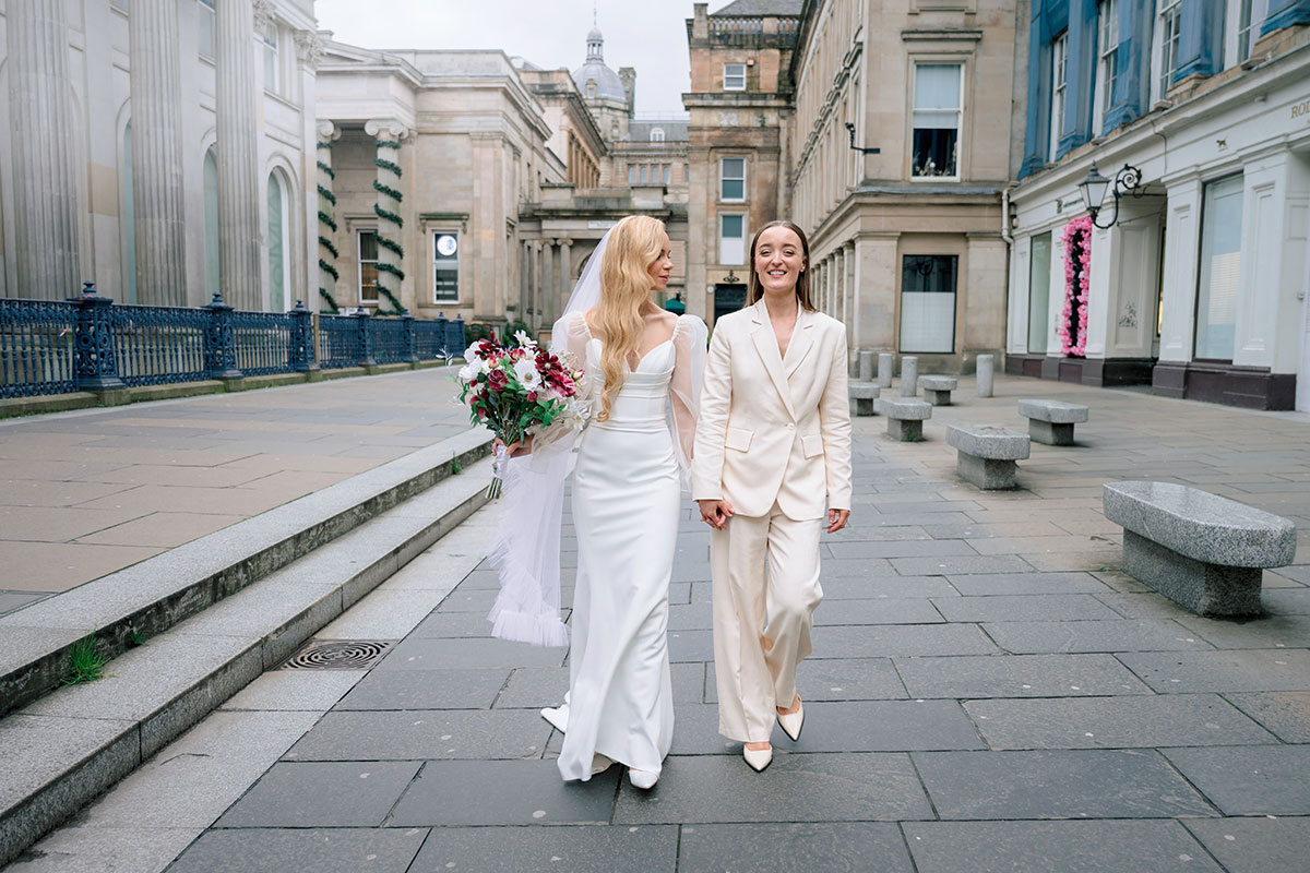 Newlyweds walking hand in hand, Royal Exchange Square Glasgow wedding photo