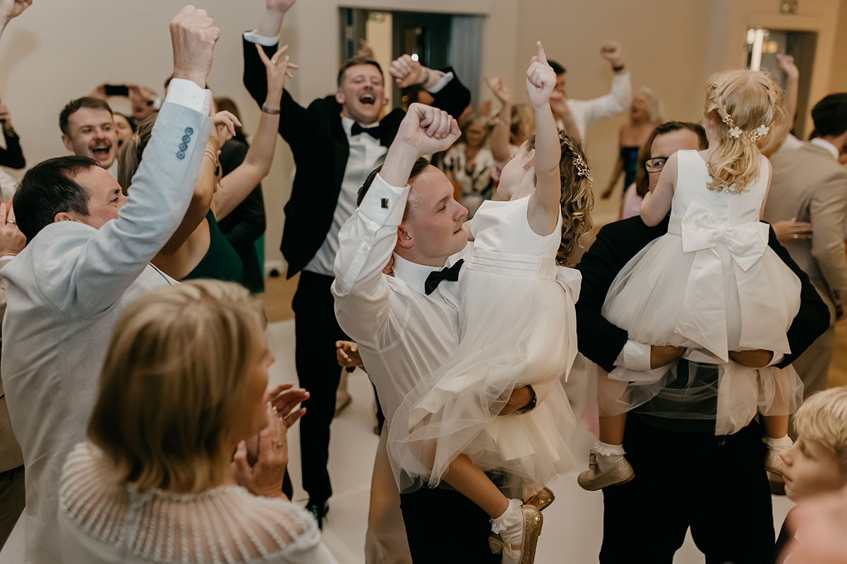 Wedding guests celebrating on the dance floor with flower girls at Boschendal Wine Estate evening reception