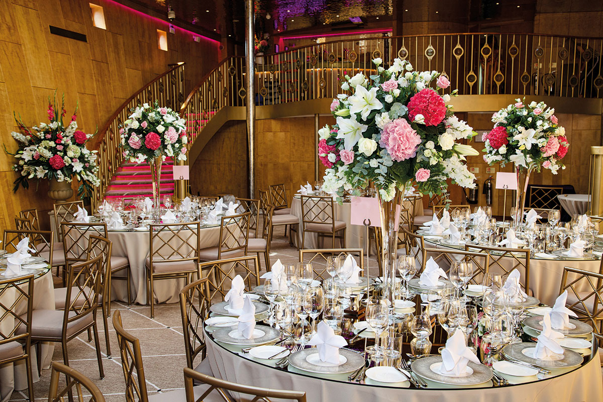 Fingal hotel Ballroom set up for wedding meal with round tables and large floral centerpieces