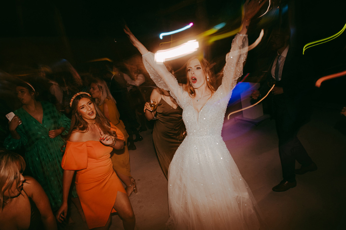 Bride dancing during evening reception 