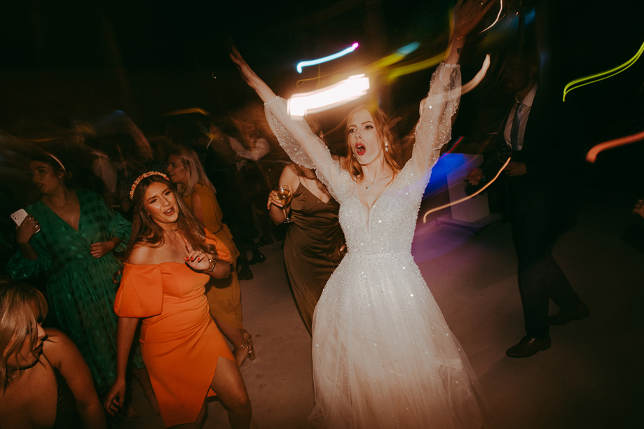 Bride dancing during evening reception