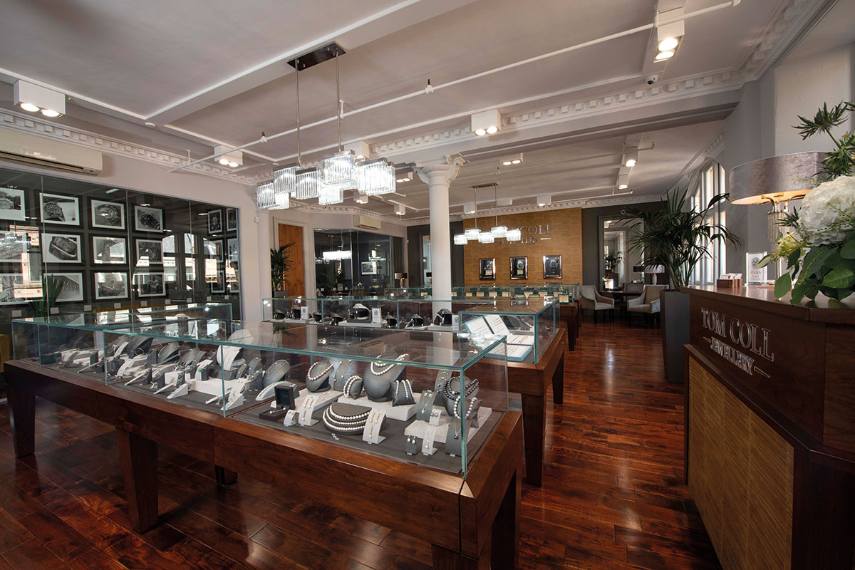 an overview of a jewellery showroom complete with glass casings and dark wooden floors
