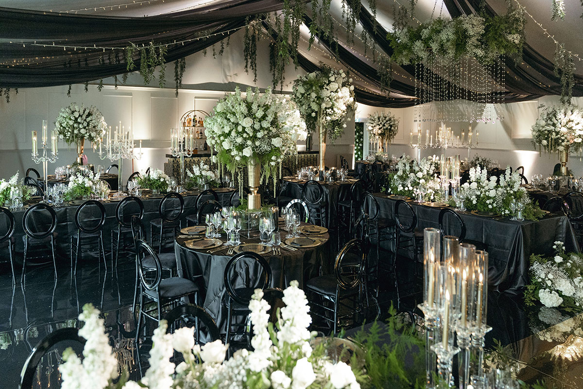 Black-and-gold Dundas Castle wedding reception with dramatic florals, chandeliers and dark romantasy décor.