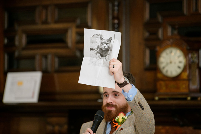 Groom holds up image of a cat during his speech