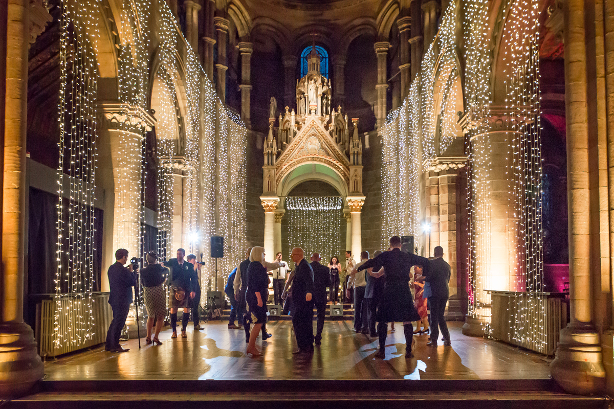 Evening ceilidh dancing beneath twinkling lights inside Mansfield Traquair, Edinburgh