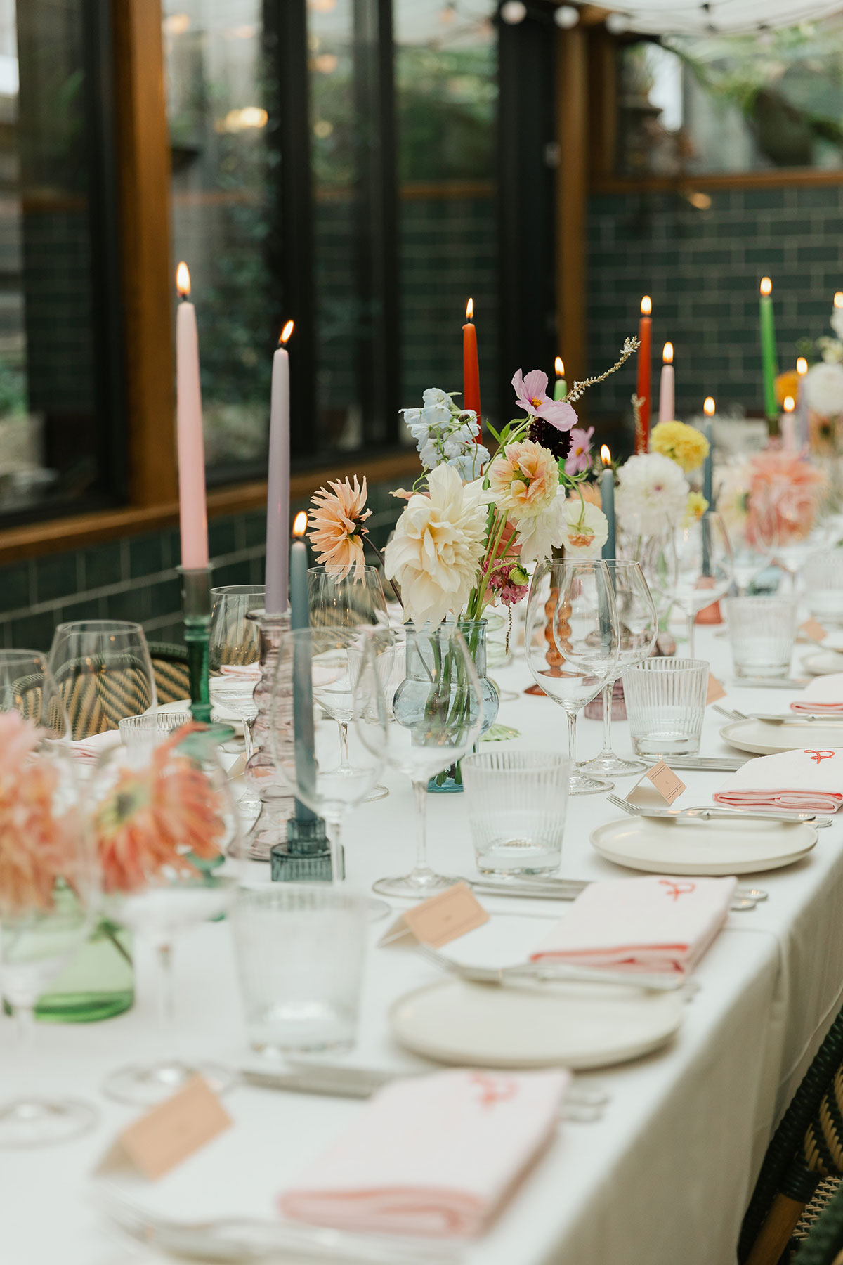 Colourful pastel wedding table setting with flowers and candles at Gleneagles Townhouse, Edinburgh.