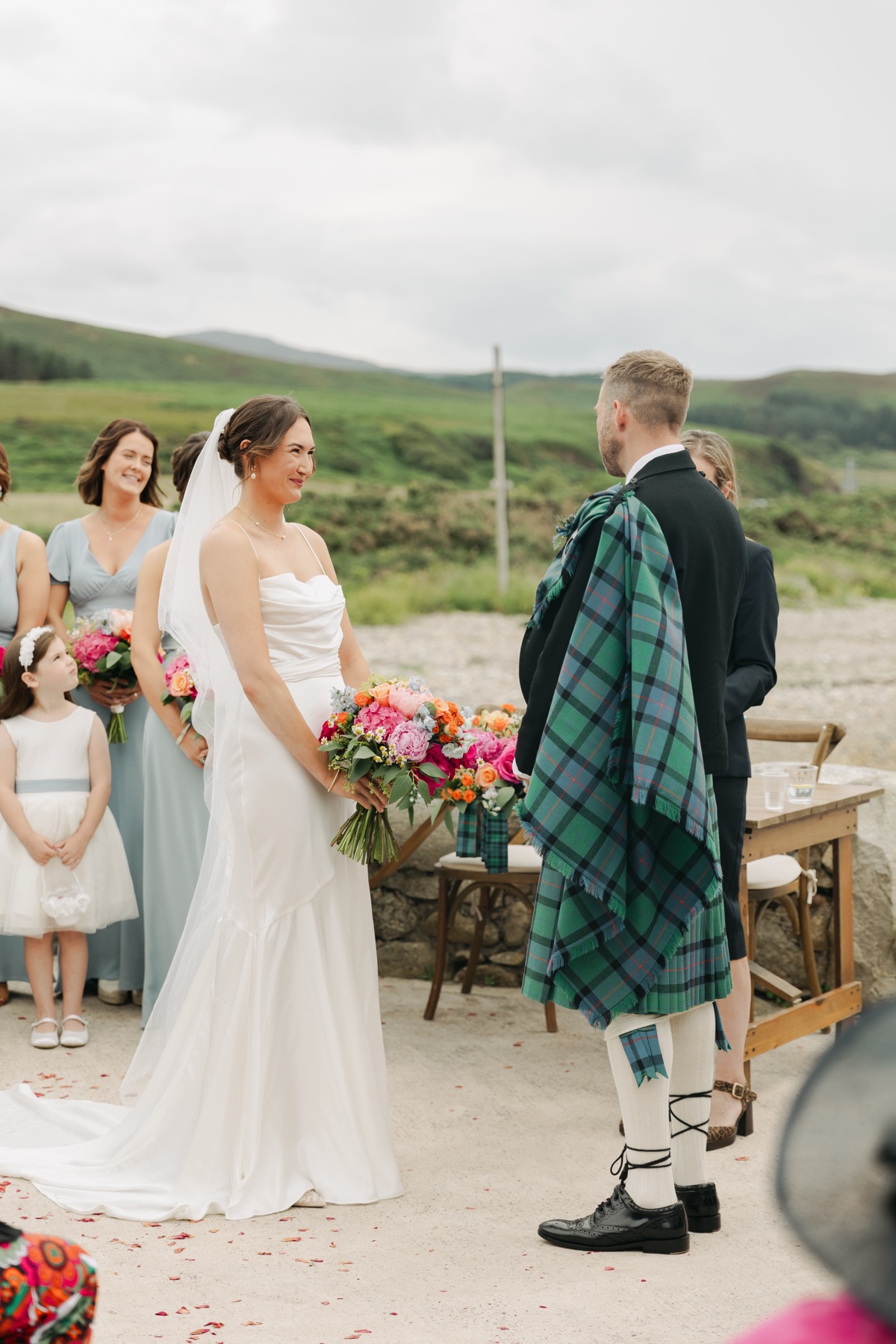 Isobel smiles at Gary during their outdoor wedding ceremony at The Dougarie Boathouse, Isle of Arran.