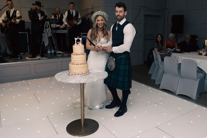 Bride and groom cut wedding cake