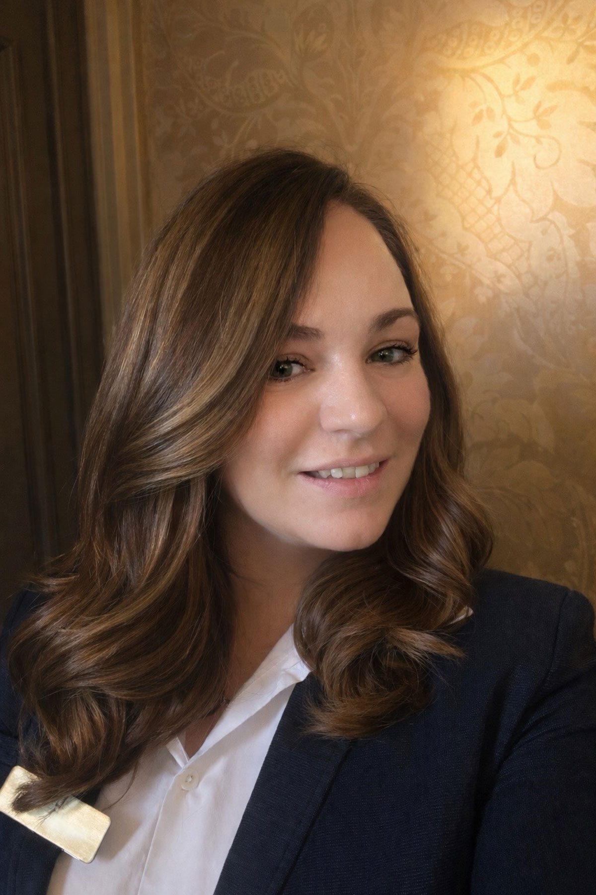 Portrait of wedding coordinator Laura Lockhart inside a luxury Scottish wedding venue, smiling in tailored blazer