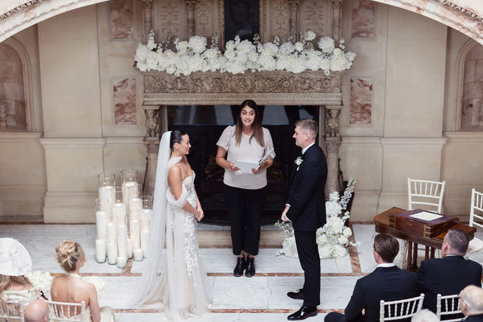 A bride and groom standing face to face during a wedding ceremony at Gosford House.