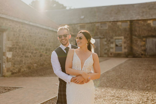 bride and groom wearing sunglasses