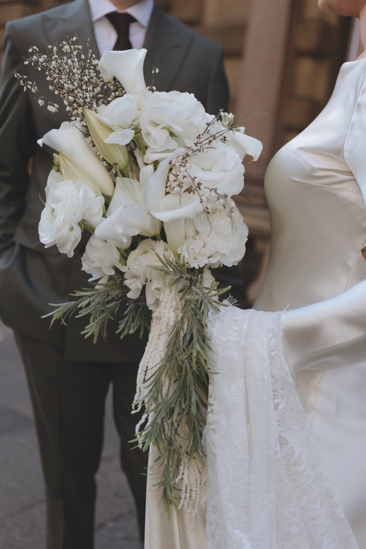 Close-up of the bride’s cascading white wedding bouquet with lilies, roses and greenery at a Glasgow city wedding.