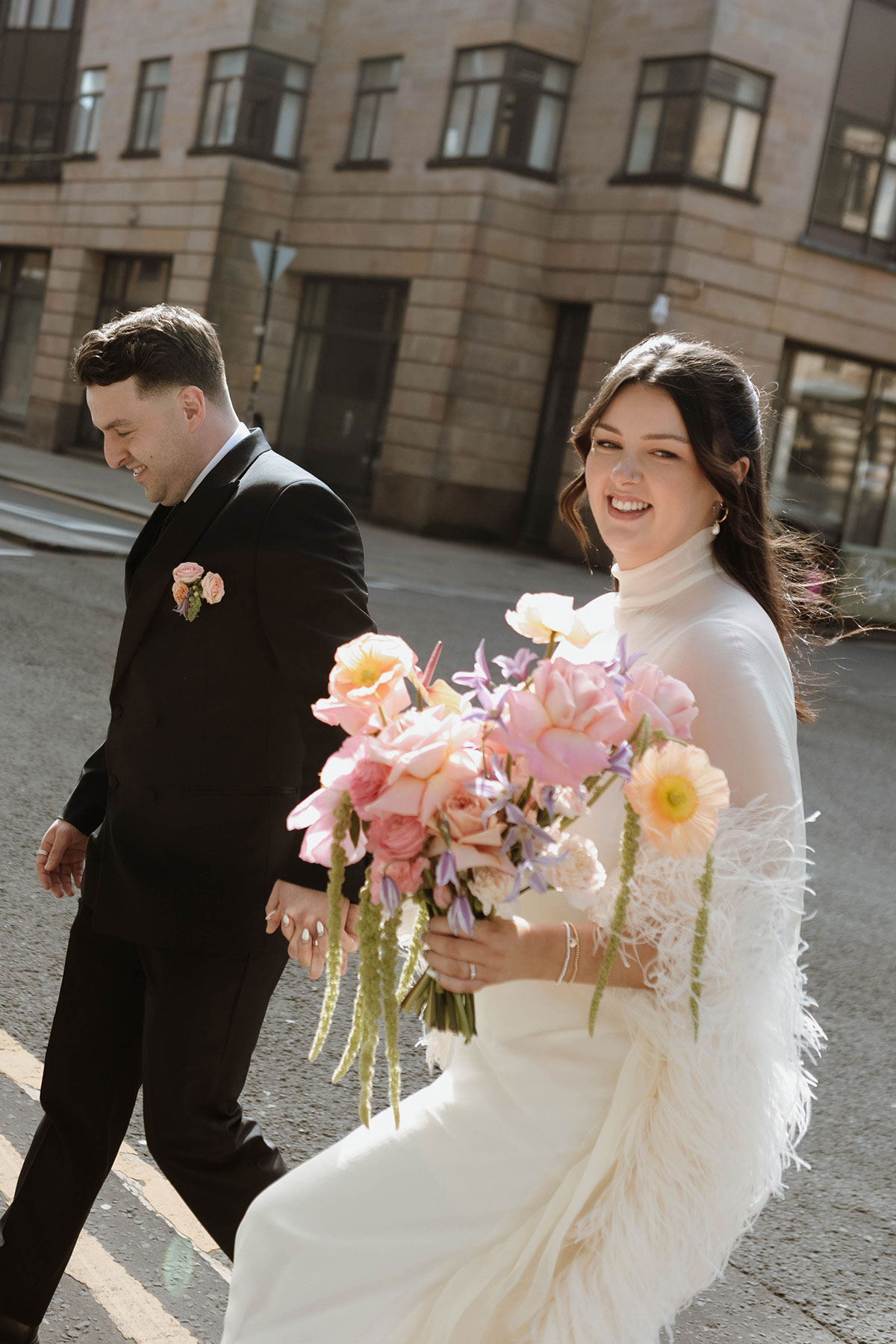 Bride holding a pastel pink bouquet during a stylish Glasgow city wedding