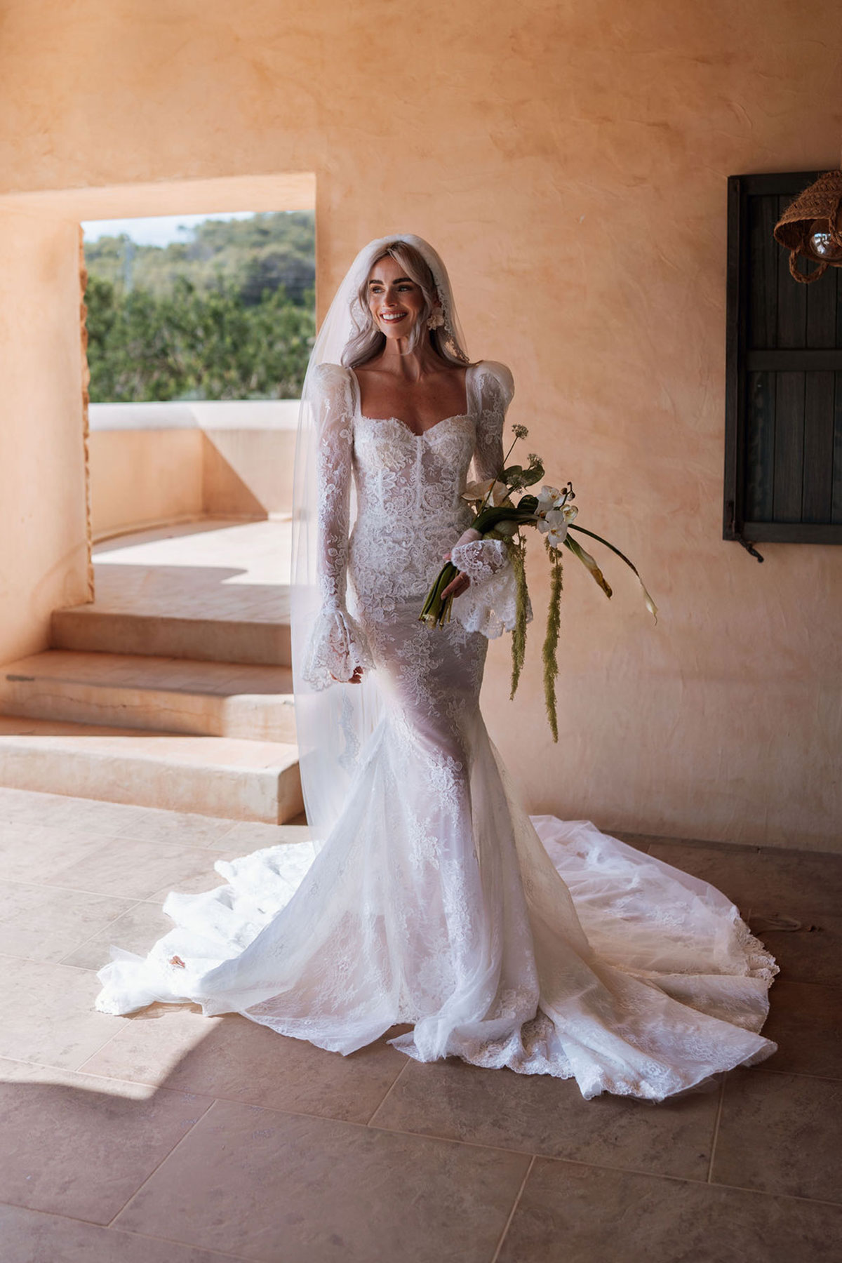 Bride wearing bespoke Carolyn Baxter Bridal long-sleeved lace wedding dress at Can Rafal Ibiza wedding venue