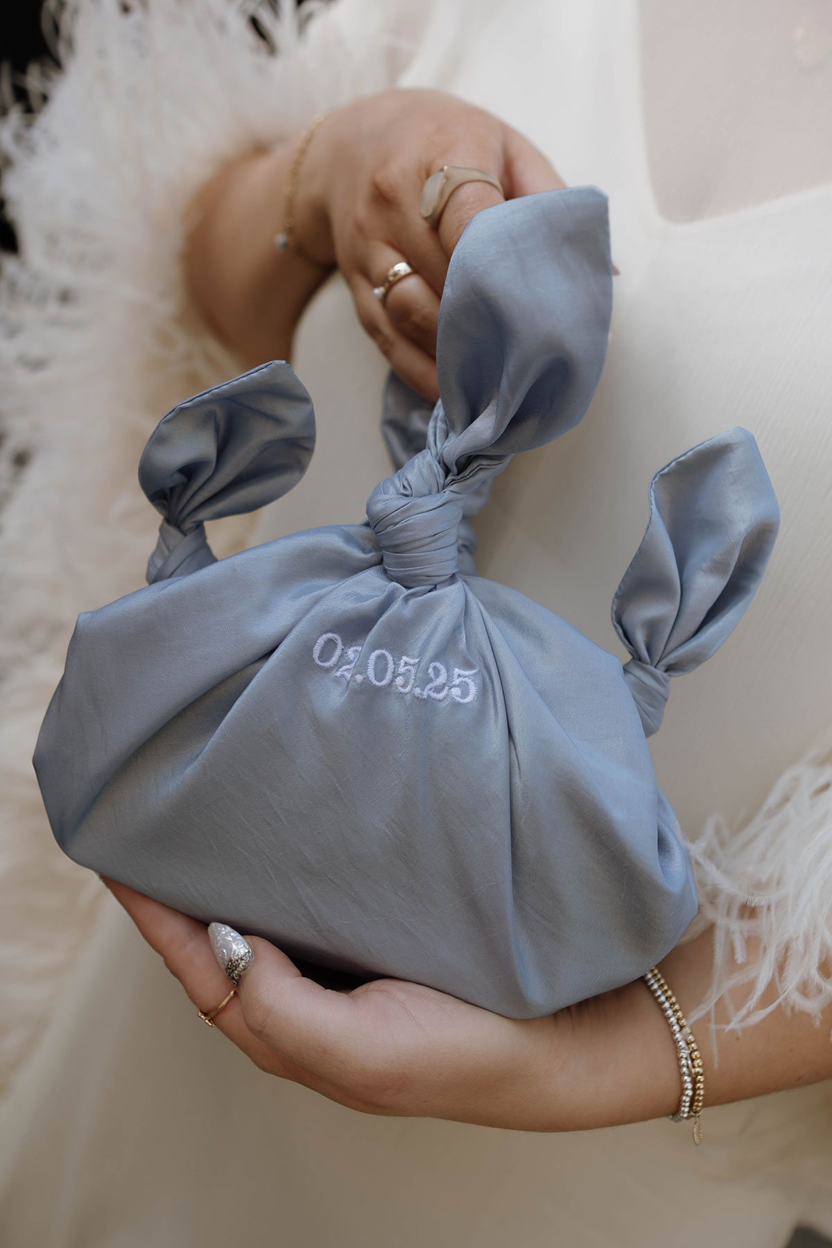 Personalised blue wedding bag embroidered with the couple’s wedding date