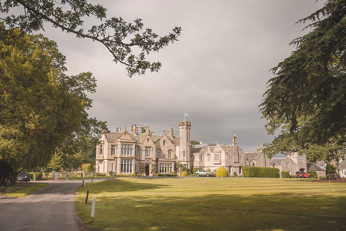 Country house surrounded by a front lawn and trees