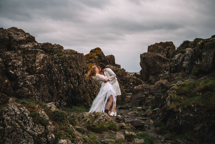 Two Brides Kissing On Rocks