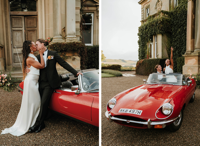 Bride and groom kiss outside venue, leaning against red convertible
