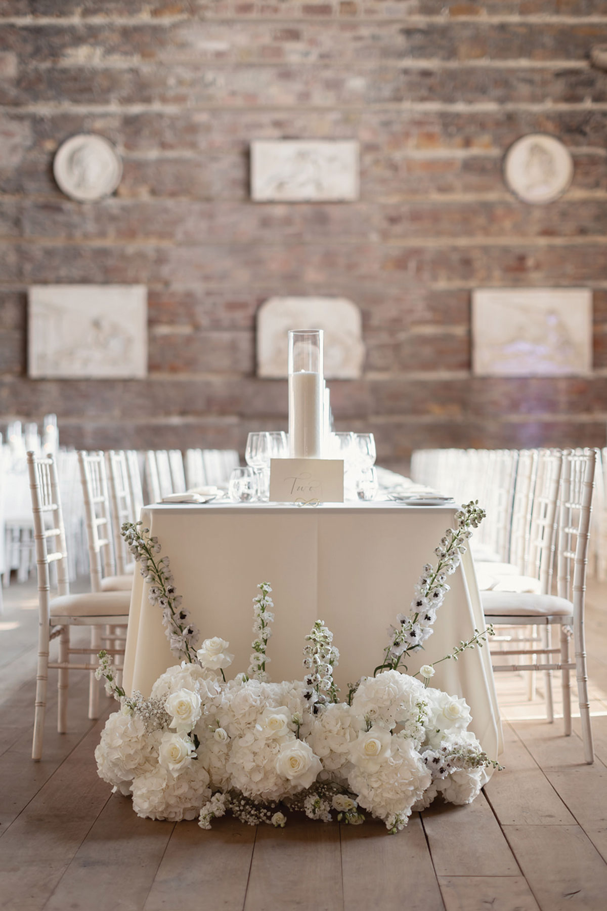 A table with white flowers and candles.