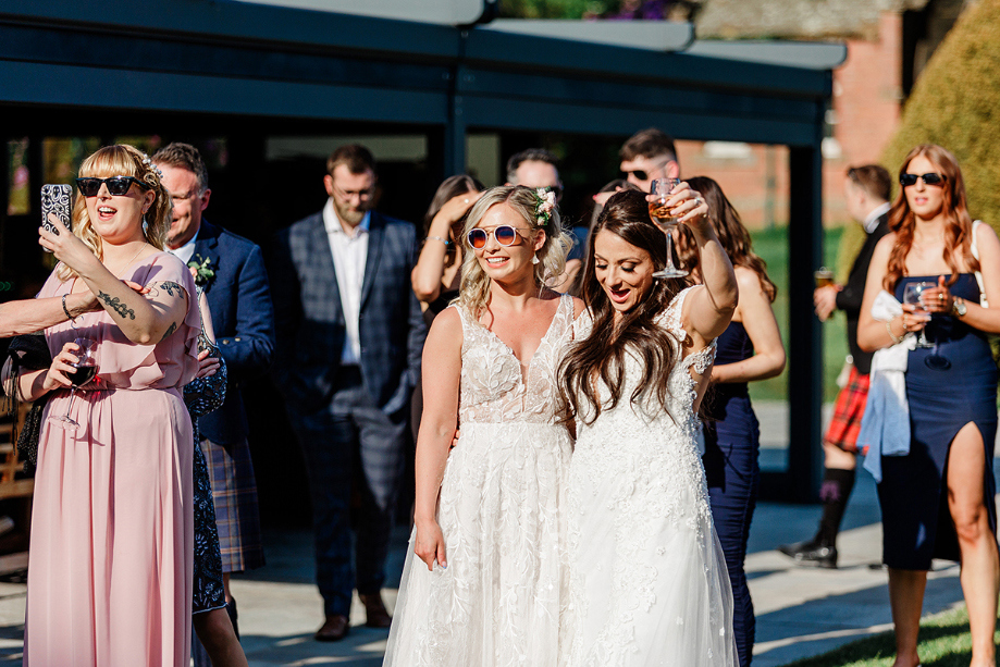 Brides and guests wait outside for entertainment
