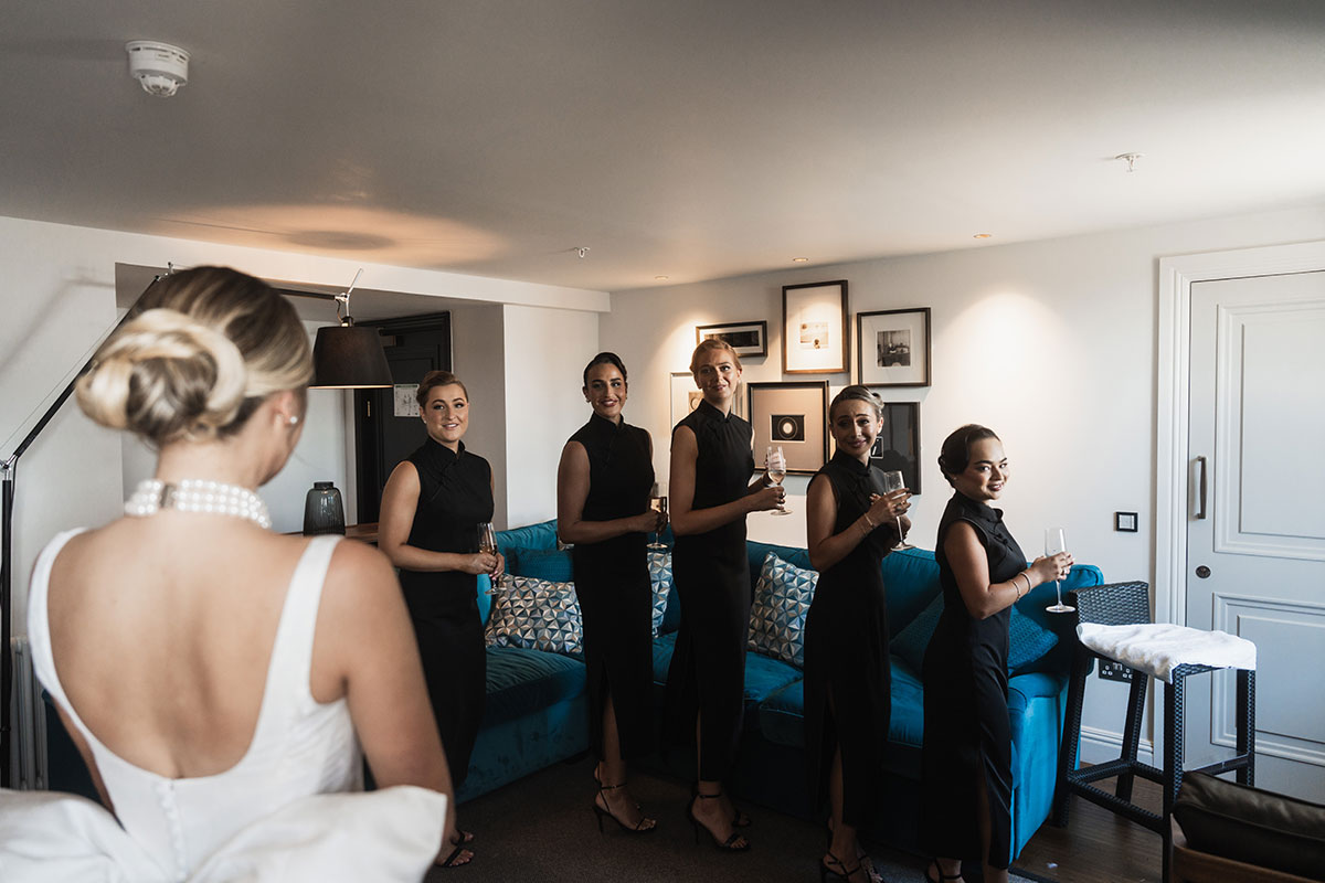 Bride reveals her dress to bridesmaids during getting-ready moment at Mansfield Traquair wedding