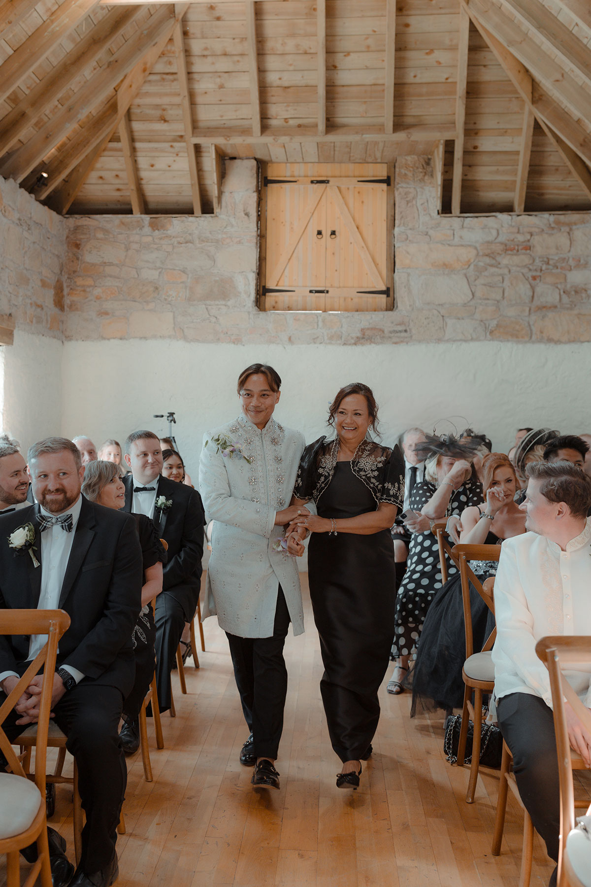 room walking down the aisle with his mum during intimate farm wedding ceremony near Falkirk, Scotland