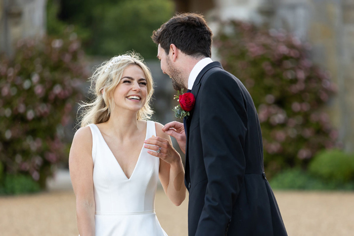 Bride and groom laugh during outdoor couple portraits