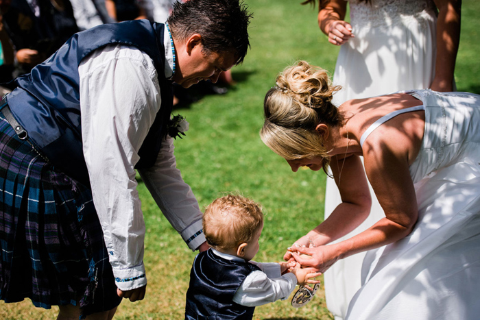 Small boy hands bride an item before ceremony