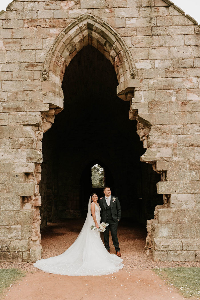 Alex and Matt Fagerson posing in ruined doorway of Dunglass Collegiate Church