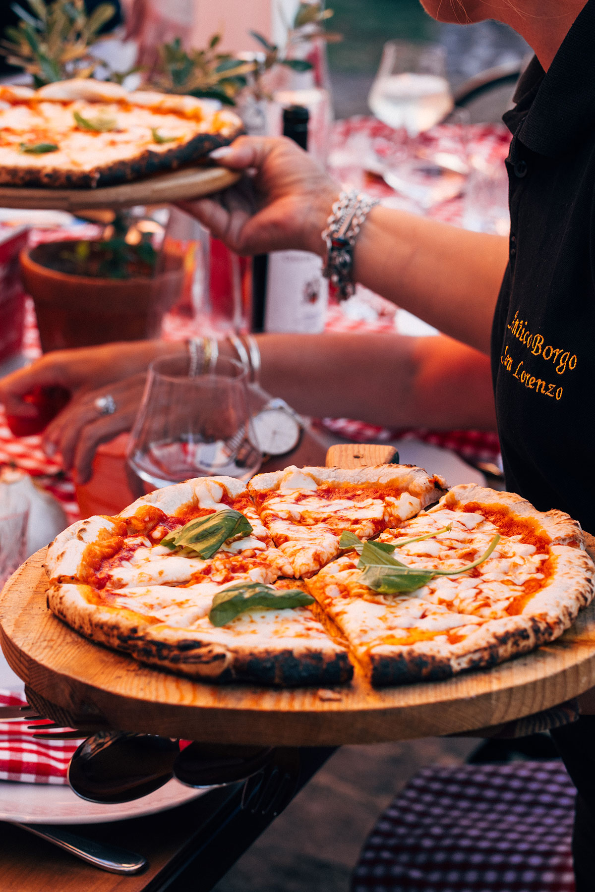 Wood-fired pizza served at wedding welcome party at Antico Borgo San Lorenzo Tuscany