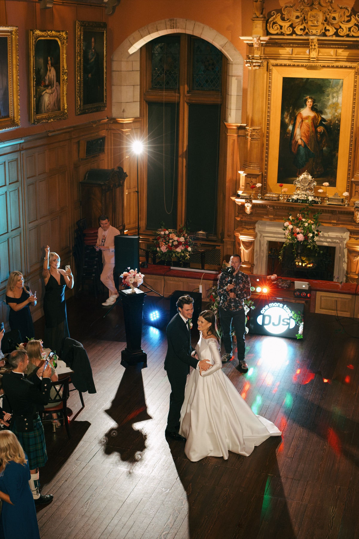 Nicole and Ryan share their first dance at Barnbougle Castle, surrounded by wedding guests in the historic reception room.