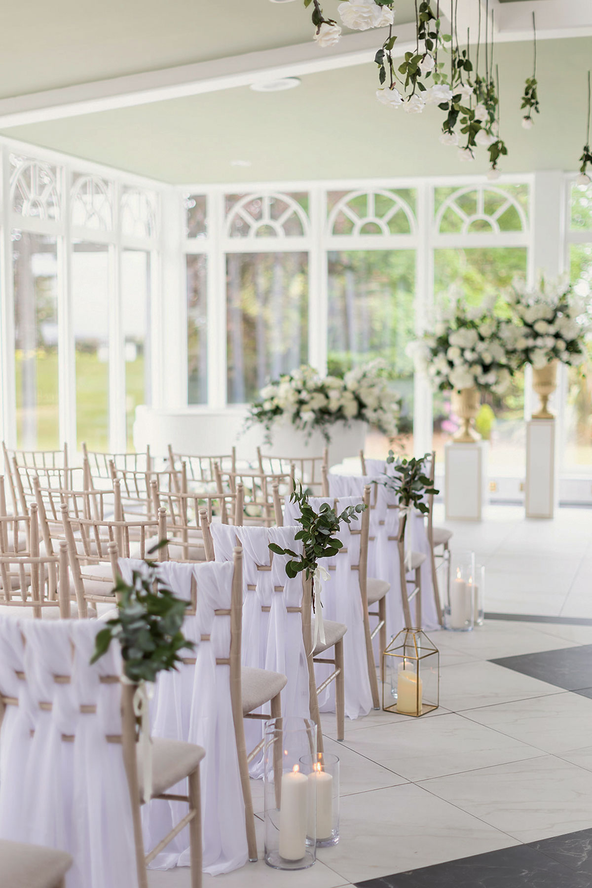 aisle seating for a wedding with draped chairs and candle accessories