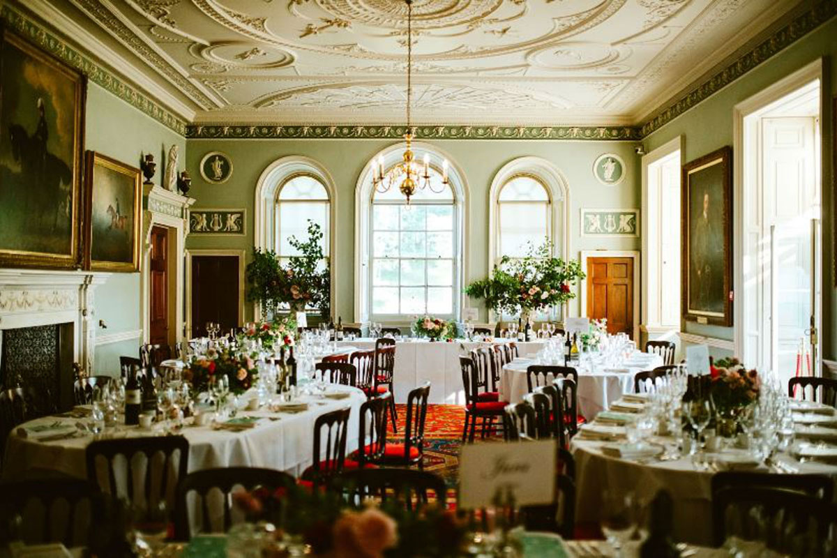 Formal wedding reception setup in Culzean Castle featuring round dining tables, floral centrepieces and ornate Georgian interiors