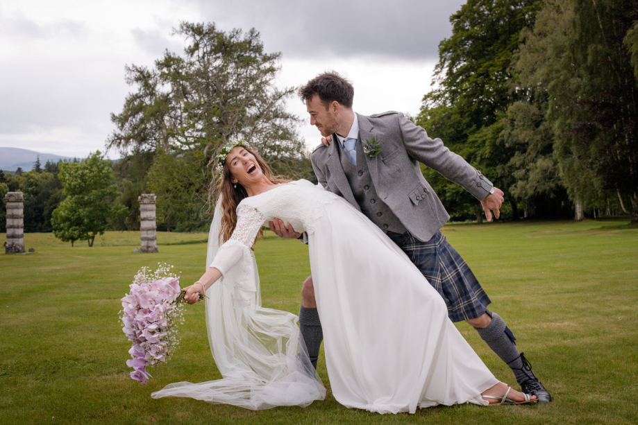 A Bride And Groom Posing In The Grounds Of Raemoir House