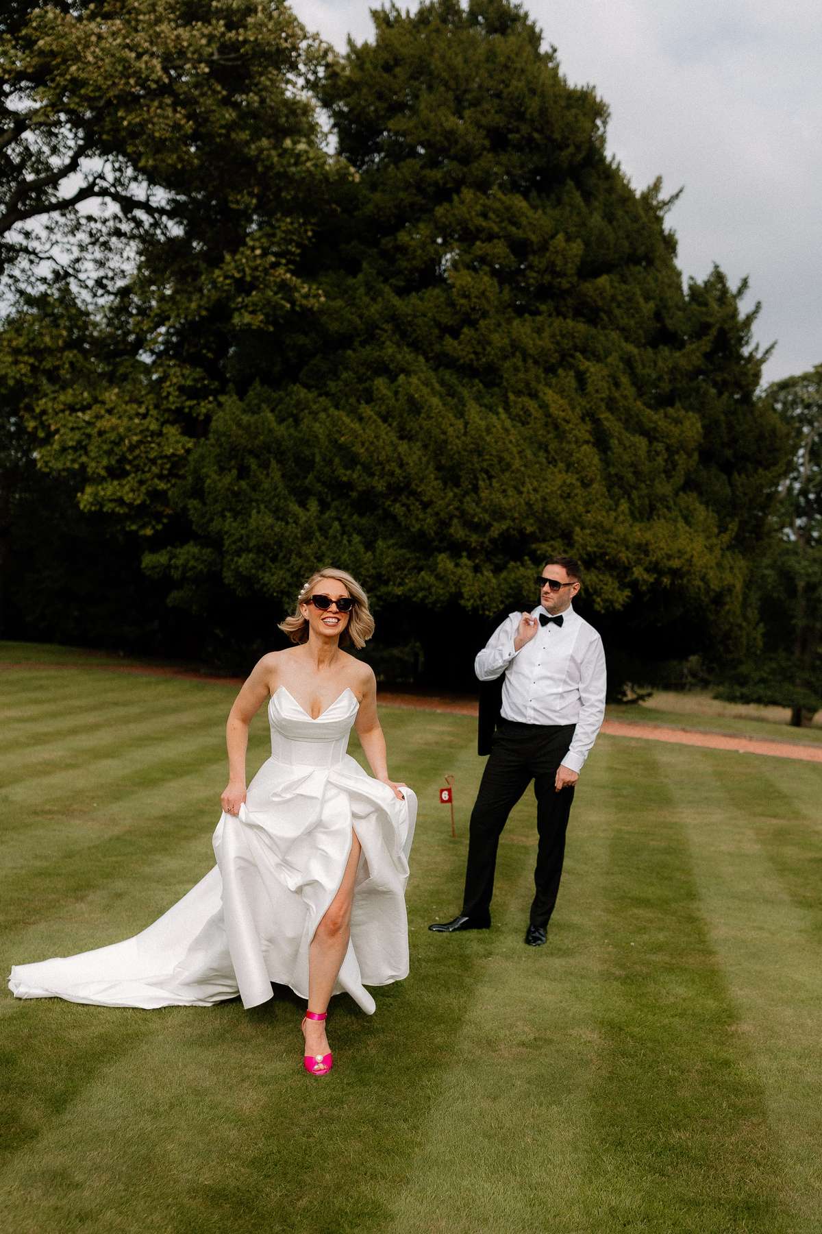 Kara and Rory have fun running during wedding portraits on the lawn at Prestonfield House in Edinburgh.