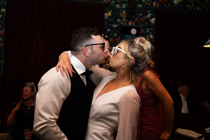 Bride And Groom Kissing Wearing Sunglasses