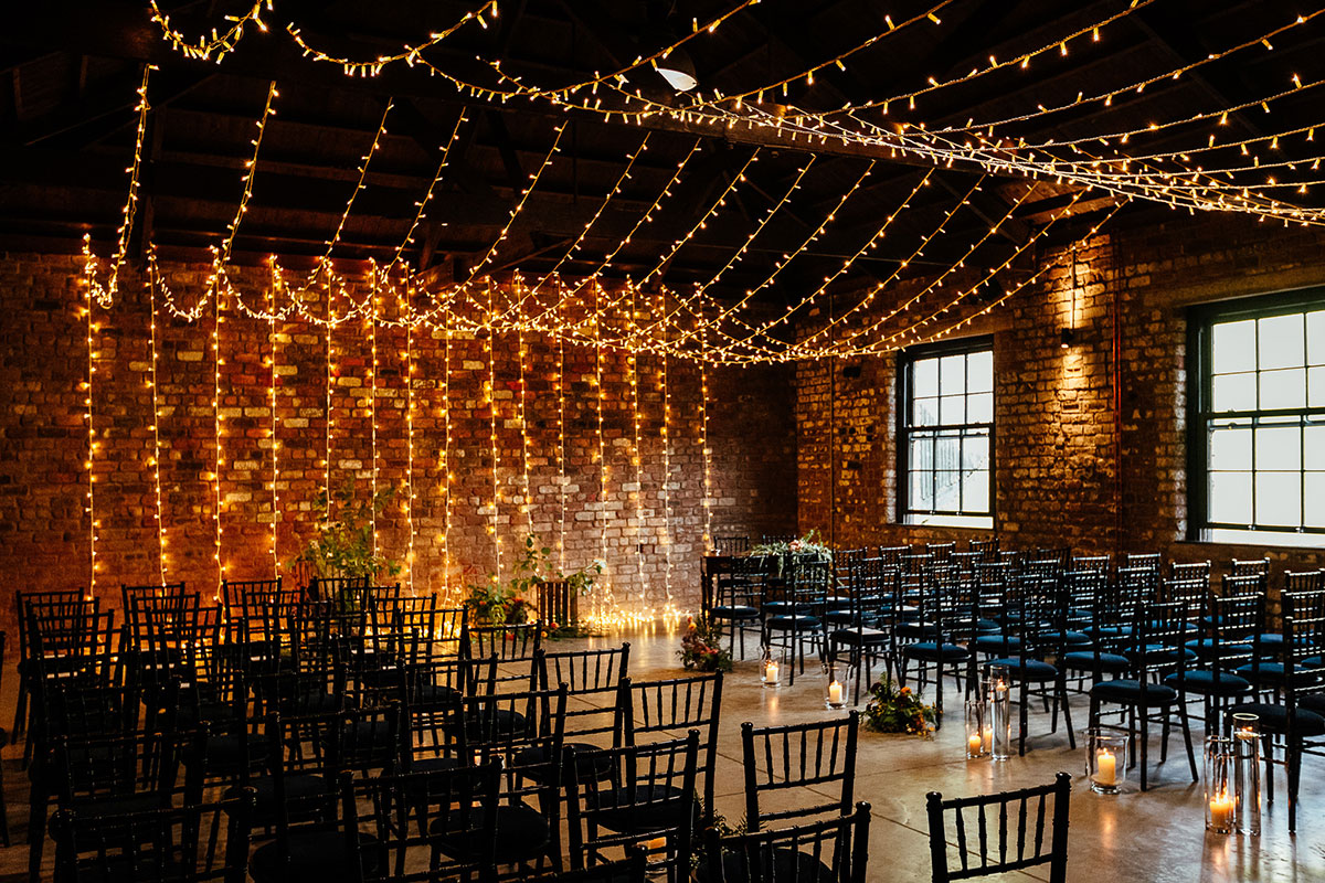 ceremony set up with fairy lights and black chairs at the engine works in glasgow