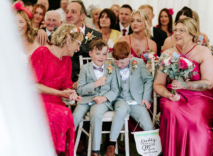 wedding guests sitting on rows of chiavari chairs