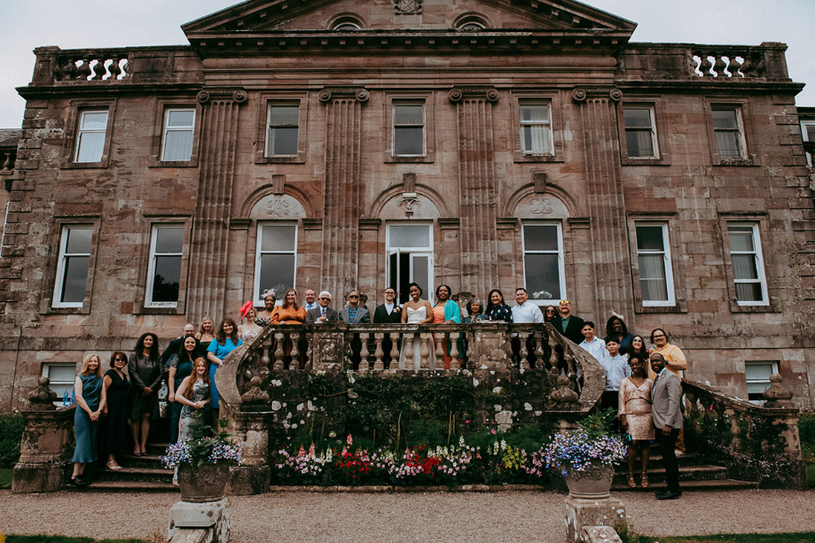 Group shot of wedding party outside venue