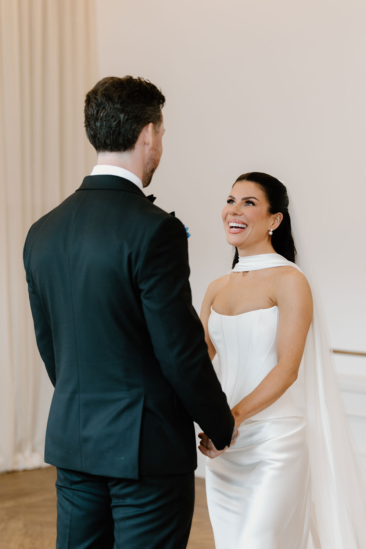 ride laughing during her wedding ceremony at The Exchange Glasgow, wearing a modern corset-style bridal gown