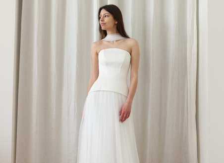 woman in white dress with fitted bodice and tulle skirt