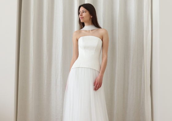 woman in white dress with fitted bodice and tulle skirt