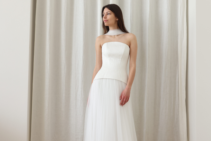 woman in white dress with fitted bodice and tulle skirt