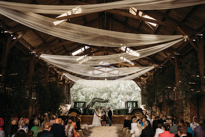 Shed At Boswells Estate With White Drapes On Ceiling And Wedding Ceremony Taking Place