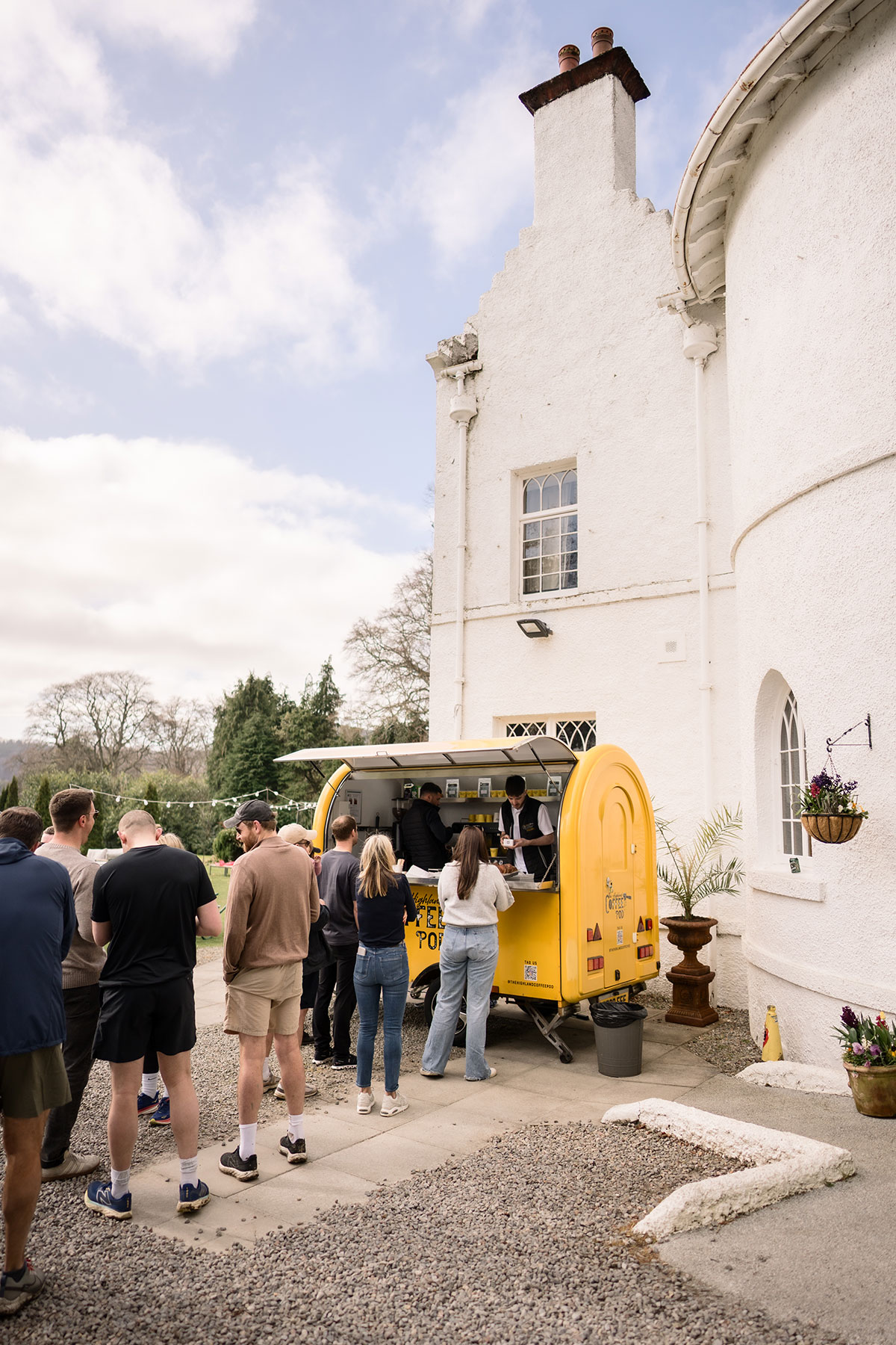 wedding guests queue for yellow food truck during wedding at Achnagairn Castle