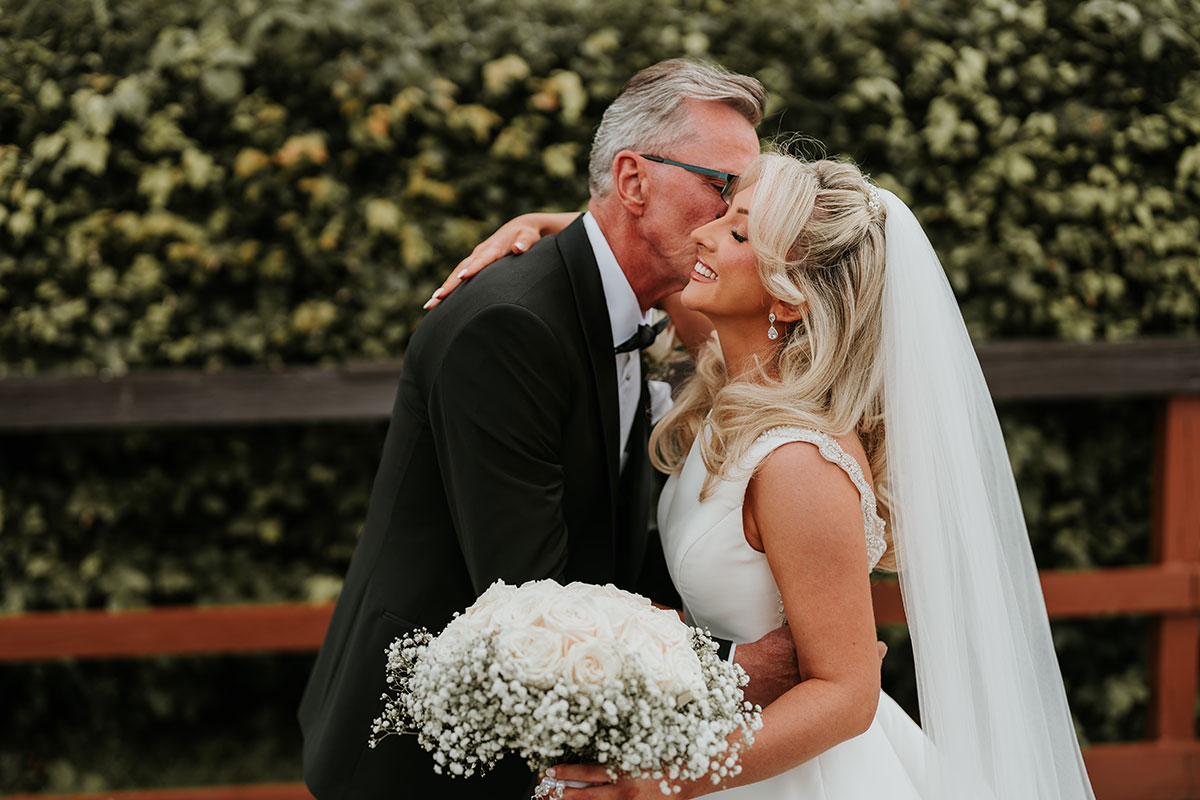 Bride sharing emotional moment with father during Ingliston Country Club wedding portraits