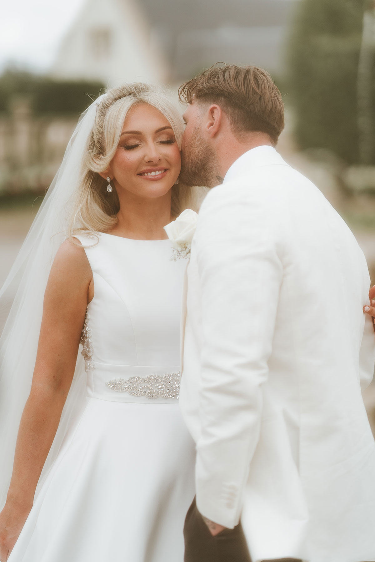 Bride and groom sharing romantic kiss during Ingliston Country Club wedding portraits